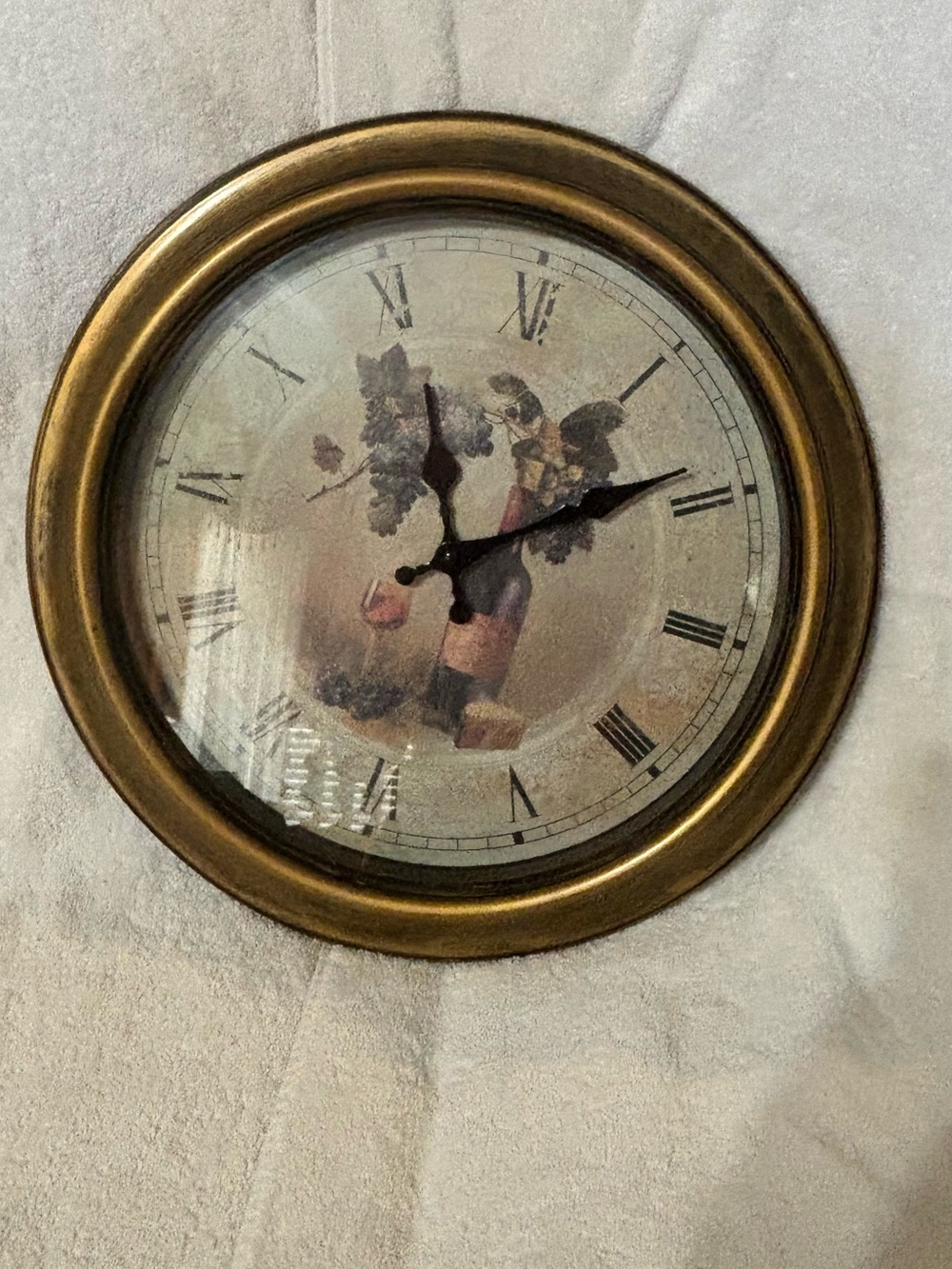Gold-Finish Round Wall Clock with Roman Numerals and Vintage Illustration